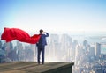 Super hero businessman on top of building ready for challenge Royalty Free Stock Photo