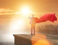 Super hero businessman on top of building ready for challenge Royalty Free Stock Photo