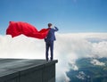 Super hero businessman on top of building ready for challenge Royalty Free Stock Photo