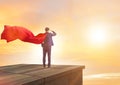 Super hero businessman on top of building ready for challenge Royalty Free Stock Photo