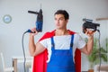 The super hero repairman working at home Royalty Free Stock Photo