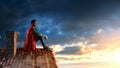 Super hero on roof. Mixed media Royalty Free Stock Photo