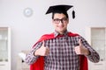 The super hero student wearing mortarboard in a red cloak