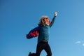 Super jump. Boy in red super hero cape and mask flying. Freedom, childhood, movement and child concept. Royalty Free Stock Photo