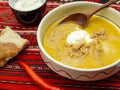 traditional romanian dish tripe soup known as ciorba de burta served with cream and pepper