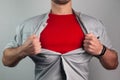 Super man in red rips the shirt on his chest Royalty Free Stock Photo