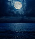 Super moon in dark clouds over sea Royalty Free Stock Photo