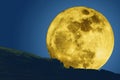 The super full moon silhouettes the mountain and a man Royalty Free Stock Photo