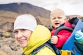 Super mother hiking with baby travelling in backpack Royalty Free Stock Photo