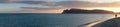 super panorama of the main beach of Cagliari (poetto sella del diavolo) with two walking lovers at sunset. Sardinia Royalty Free Stock Photo