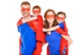 super parents piggybacking happy kids in masks and cloaks Royalty Free Stock Photo