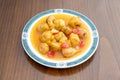 Super plate of Chinese sweet and sour pork with pieces of peach in syrup, pear and red cherries Royalty Free Stock Photo