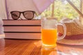 Super Protection from the sun. Sunburn risk concept. Umbrella protecting beautiful woman things. Books, sunglasses, orange juice