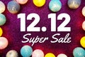 12.12 Super Sale text and LED cotton Balls Decoration on pink Glitter background