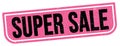 SUPER SALE text written on pink-black stamp sign