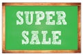 SUPER SALE words on green wooden frame school blackboard