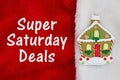 Super Saturday Deals with Christmas gingerbread house on red and white plush textured fabric