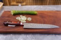 Super sharp Japanese kitchen knife with ultra thin slice zucchini on wooden chopping board