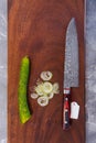 Super sharp Japanese kitchen knife with ultra thin slice zucchini on wooden chopping board