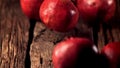 Super slow motion ripe pomegranats roll down wooden boards. Filmed on a high-speed camera at 1000 fps.