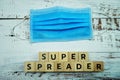 Super Spreader word letter on wooden background