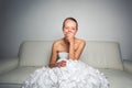 Super tired gorgeous bride sitting on a sofa Royalty Free Stock Photo