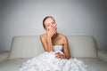 Super tired gorgeous bride sitting on a sofa Royalty Free Stock Photo
