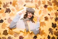 It is super warm. Fall look of vogue model. Fashion girl look through torn paper with autumn leaves. Pretty woman wear Royalty Free Stock Photo