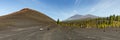 Super wide panoramic view of Volcano Arenas Negras and lava fields around. Bright blue sky and white clouds. Teide National Park Royalty Free Stock Photo