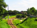 Superb pedestrian bridge with walking people on a railway in the nature in Zamosc in Poland
