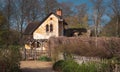 A superb rustic farm, very well maintained with a brick facade, oval windows, a thatched roof, a building located in the middle of Royalty Free Stock Photo