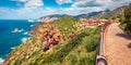 Superb summer cityscape of Nebida town with Porto Corallo on background. Panoramic morning view of Sardinia island, Italy, Europe.