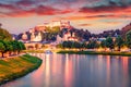 Superb summer view of Old town of Salzburg. Colorful sunset cityscape of Salzburg with Hohensalzburg Castle on background. Austria