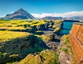 Superb summer view of small fishing village at the foot of Mt. Stapafell - Arnarstapi or Stapi.