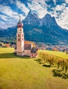 Superb view from flying drone of St. Valentin Kastelruth church with Petz peak on background.