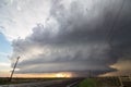 A supercell storm towers over a lonely highway in the plains. Royalty Free Stock Photo