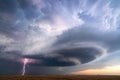 Supercell thunderstorm with lightning bolt and dark storm clouds Royalty Free Stock Photo