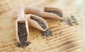 Superfood chia seeds in wooden scoops close-up Royalty Free Stock Photo