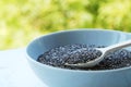 Superfood chia seeds in a wooden spoon in a bowl on the table close-up. Royalty Free Stock Photo