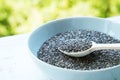 Superfood chia seeds in a wooden spoon in a bowl on the table close-up. Royalty Free Stock Photo