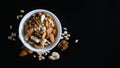 superfood concept, almond, cedar, walnuts, cashew nuts in a plate on a black background Royalty Free Stock Photo