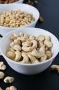 superfood concept, cedar, walnuts, cashew nuts in a plate on a black background Royalty Free Stock Photo