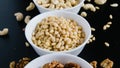 superfood concept, cedar, walnuts, cashew nuts in a plate on a black background Royalty Free Stock Photo