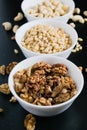 superfood concept, cedar, walnuts, cashew nuts in a plate on a black background Royalty Free Stock Photo