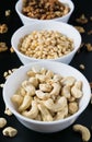 superfood concept, cedar, walnuts, cashew nuts in a plate on a black background Royalty Free Stock Photo