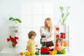 Superfood family concept. Happy loving family. Mom daughter and son prepare a smoothie in the kitchen. Have fun and play Royalty Free Stock Photo