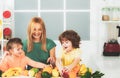 Superfood family concept. Healthy kids food. Mother daughter and little son preparing healthy smoothie in the modern Royalty Free Stock Photo