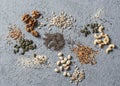 Superfood ingredients. Assortiment seeds and nuts on a gray background, top view. Flax seeds, sesame seeds, walnuts, sunflower see Royalty Free Stock Photo