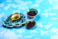 Superfoods antioxidant of indian mapuche. Bowl of fresh maqui berry on blue background, top view Authentic lifestyle image