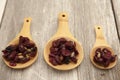 Superfoods, cranberry, raisins, and sunflowers on wooden spoons. Royalty Free Stock Photo